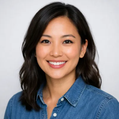 Photorealistic avatar portrait of a diverse adult with casual attire, warm smile, studio lighting, and neutral background.